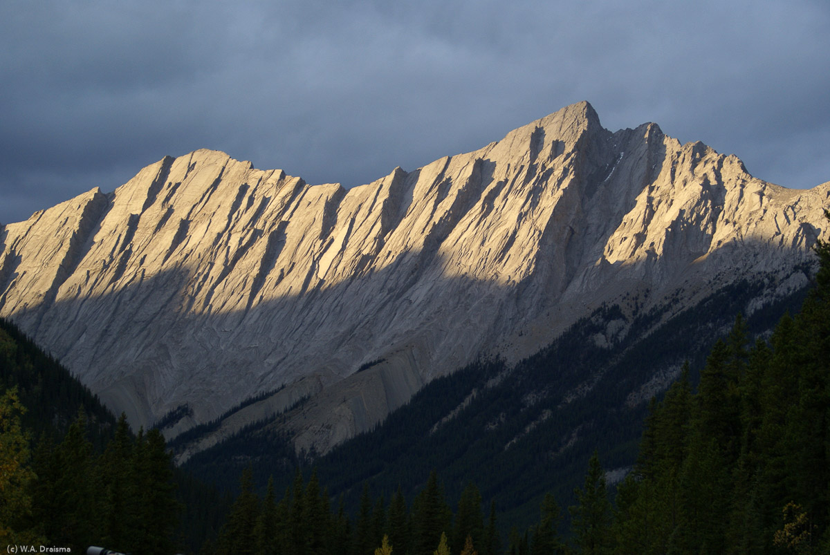 The setting sun catches the peaks of the Colin Range behind Medicine Lake in Jasper National Park.