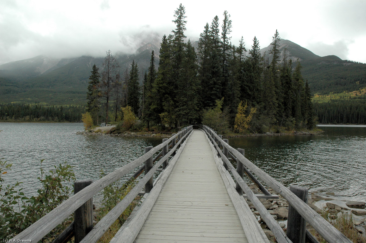 A wooden bridge gives access to Pyramid Island, a tiny island in Pyramid Lake, one of a couple of serene lakes behind the town of Jasper.