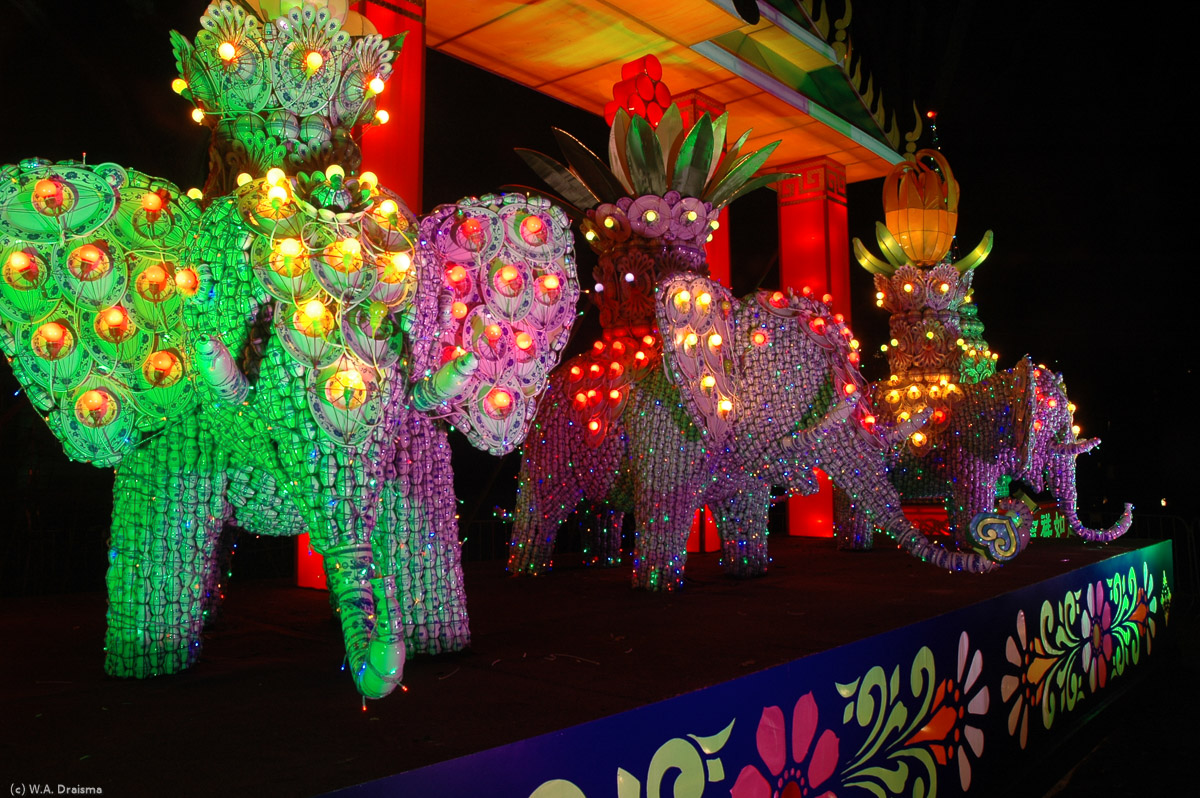 The elephant in the middle is purple, the two elephants on the outside change from purple to green.