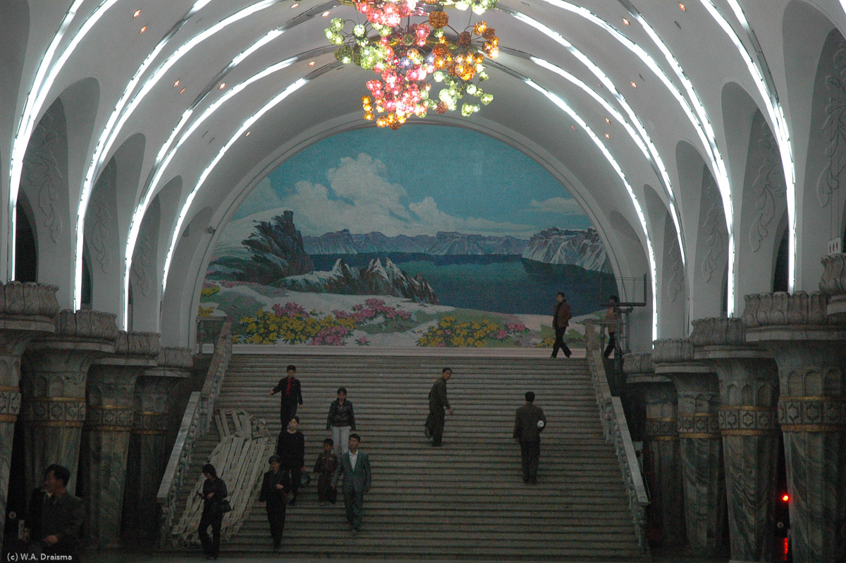 The trains run very frequently, reportedly moving 300,000 commuters per day. Passing a beautiful mosaic of Mt. Paektu we walk towards the long escalator to resurface again.