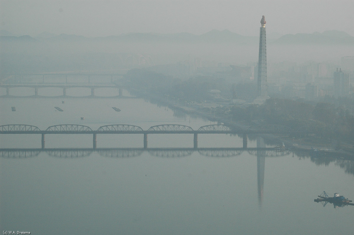 From our hotel room in the Yanggakdo we see the Juche Tower on the banks of the Taedong river barely visible through the early morning fog.