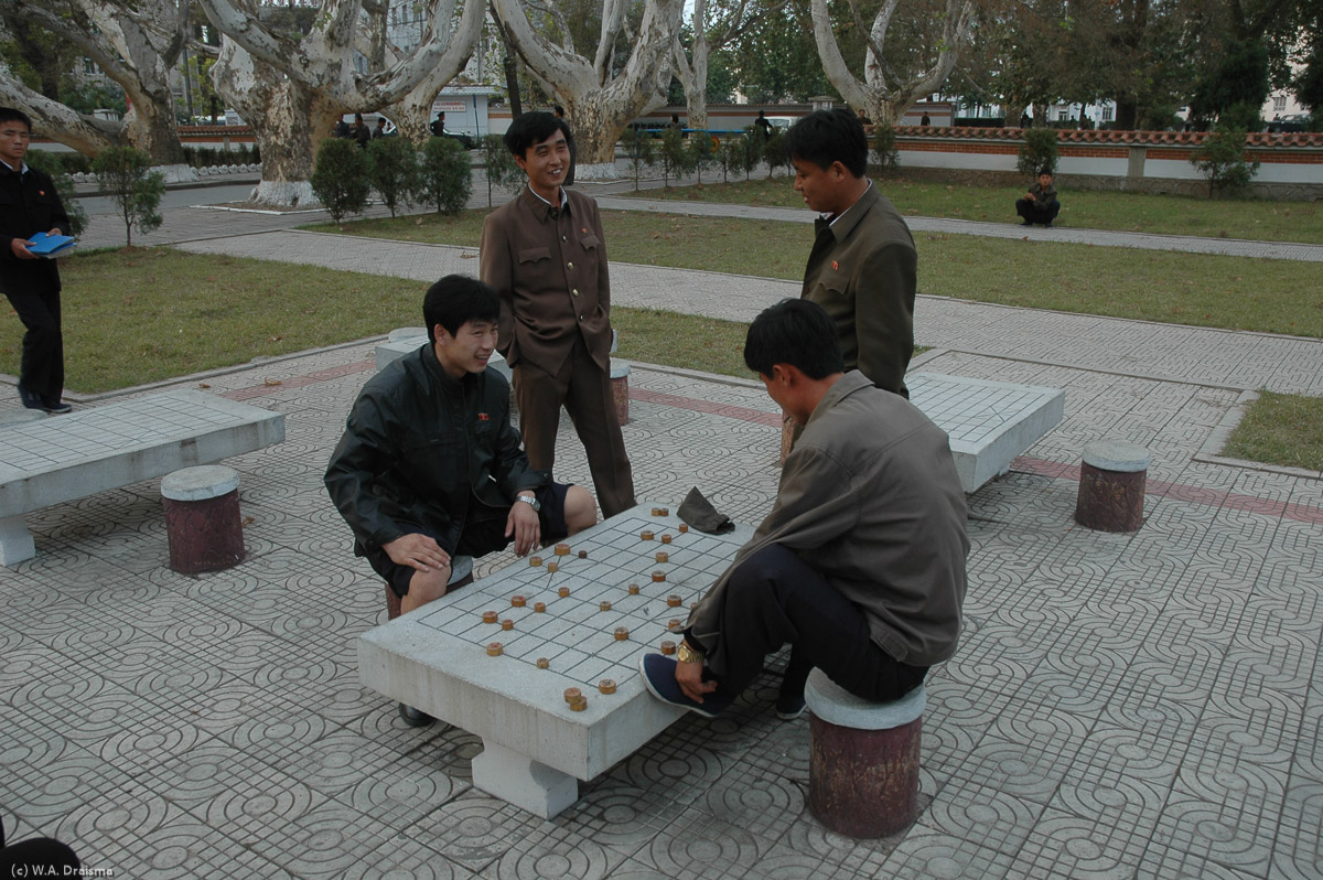 Local boys are playing some traditional board game in Folk Customs Street.