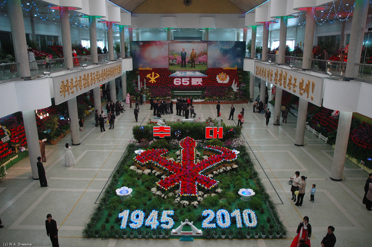 Interspersed among the potted plants were occasional models of items representing the two leaders' great achievements, such as the Great Leader's Juche Idea.