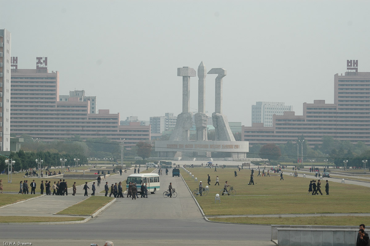 The opposite side of the street is the location of the Monument to Party Foundation with the three symbols of the Workers' Party of Korea, the hammer (i.e. worker), sickle (i.e. farmer) and calligraphy brush (i.e. intellectual).