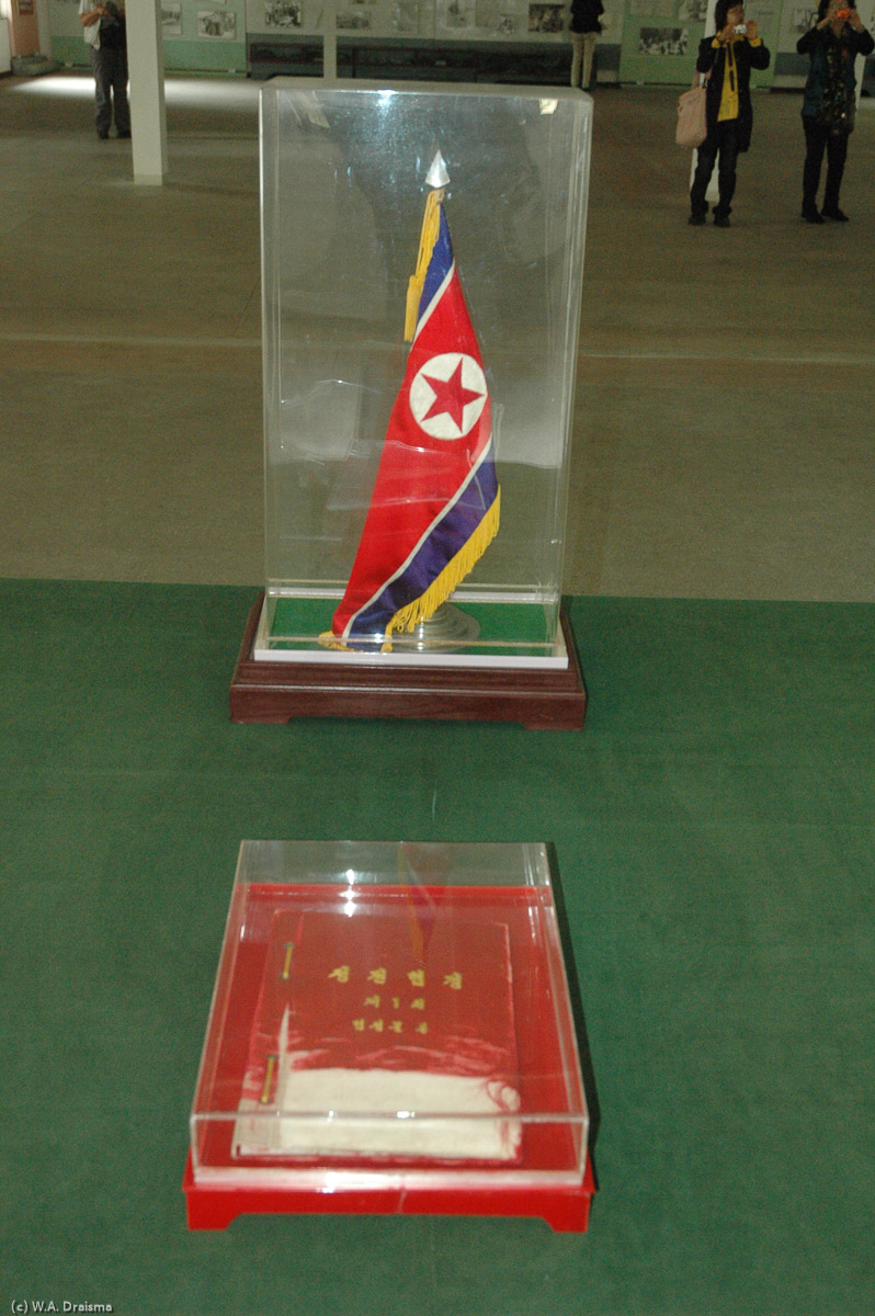 On the left is the North Korean flag and the ceasefire agreement in Korean. Supposedly, the colors of the North Korean flag are still perfect after 50 years while the colors of the blue UN flag have faded.