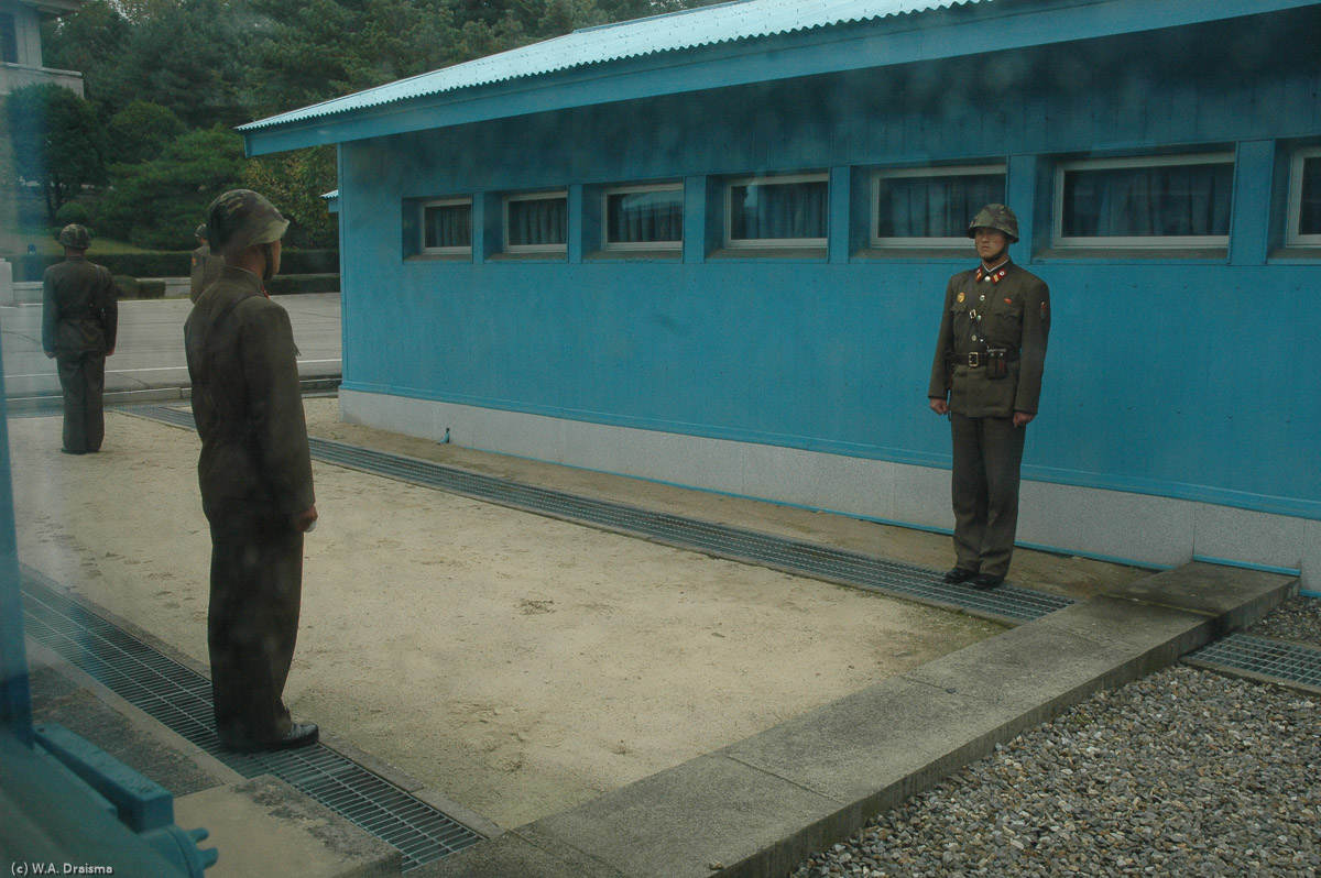 We're taken into one of the huts, the Military Armistice Conference Hall. Here we can actually stand on South Korean territory looking to the guards on the northern side of the border.