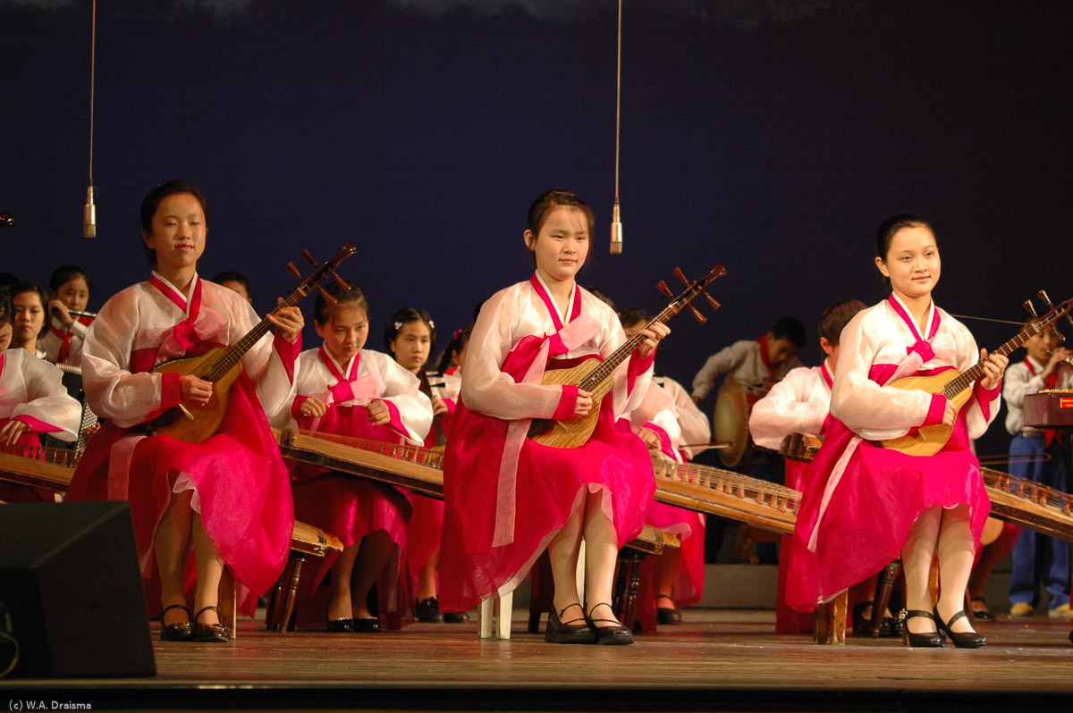 Three girls playing a type of Bipa. It's a traditional Korean music instrument with four or five strings. We've seen these girls practicing earlier in the afternoon when we visited several class rooms.