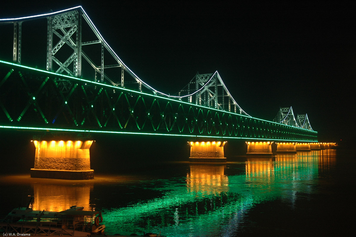 The Sino-Korean Friendship Bridge linking the Chinese city of Dandong to the North Korean city of Sinuiju. North Korea starts where the lights dim.