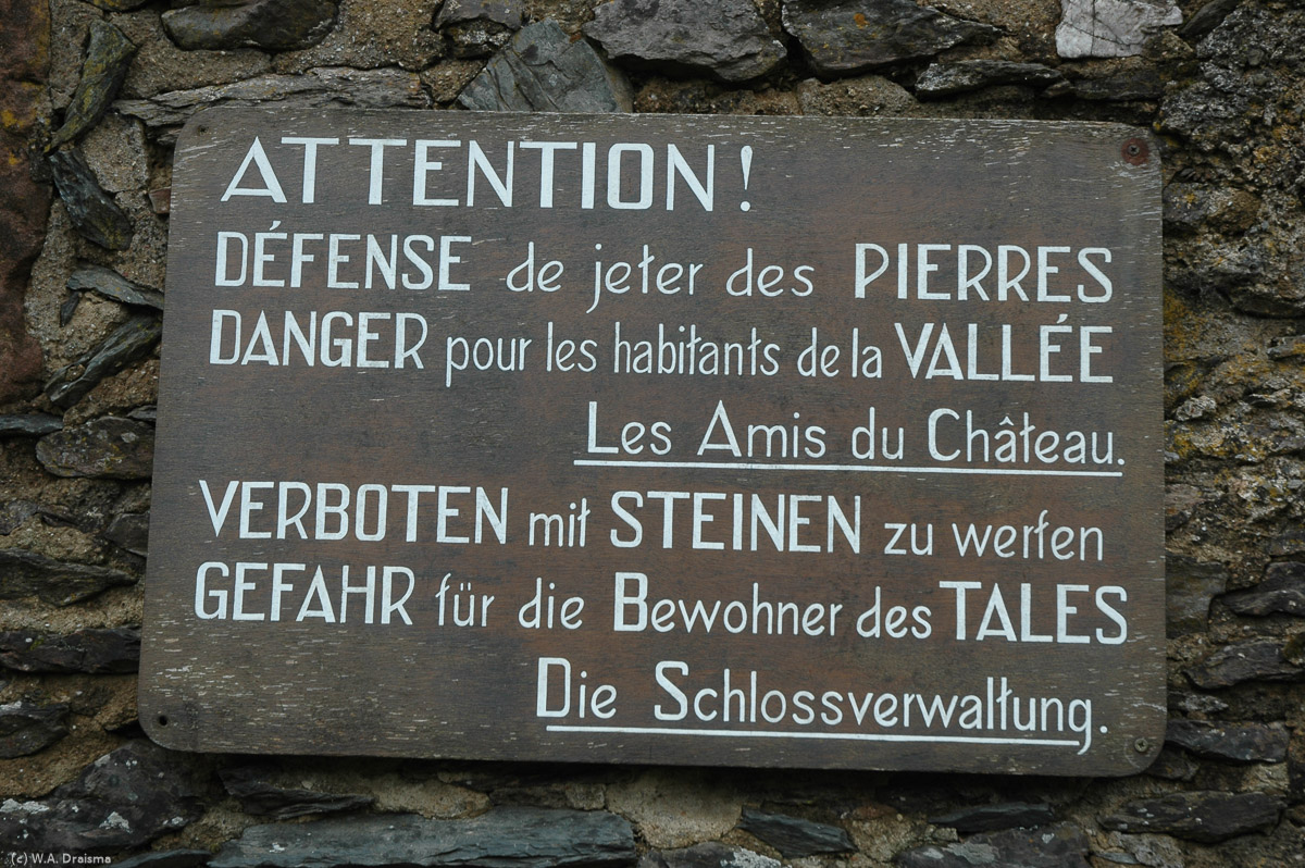 The castle can be entered through five gates, the first one having a draw bridge. A wooden sign warns present day visitors to behave well whilst in the castle.