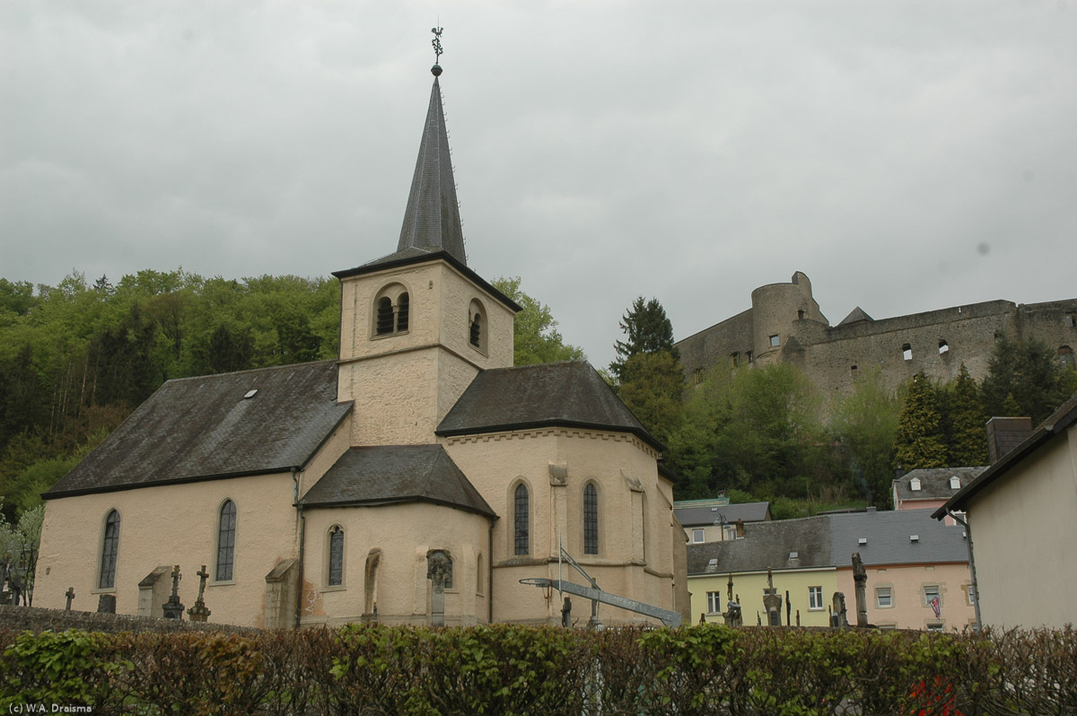 The church of Septfontaines with its 11th century castle in the background.