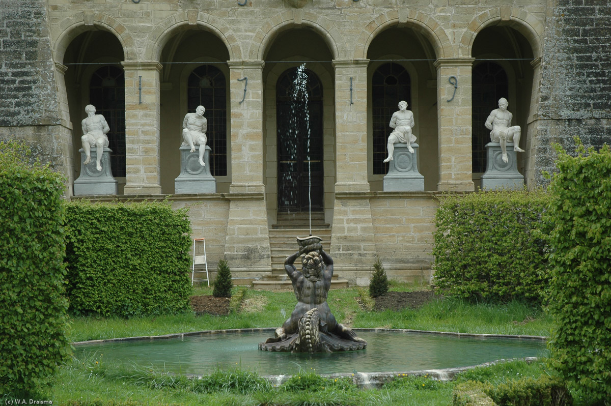 The garden side of the chateau contains four life-size statues in sitting positions.