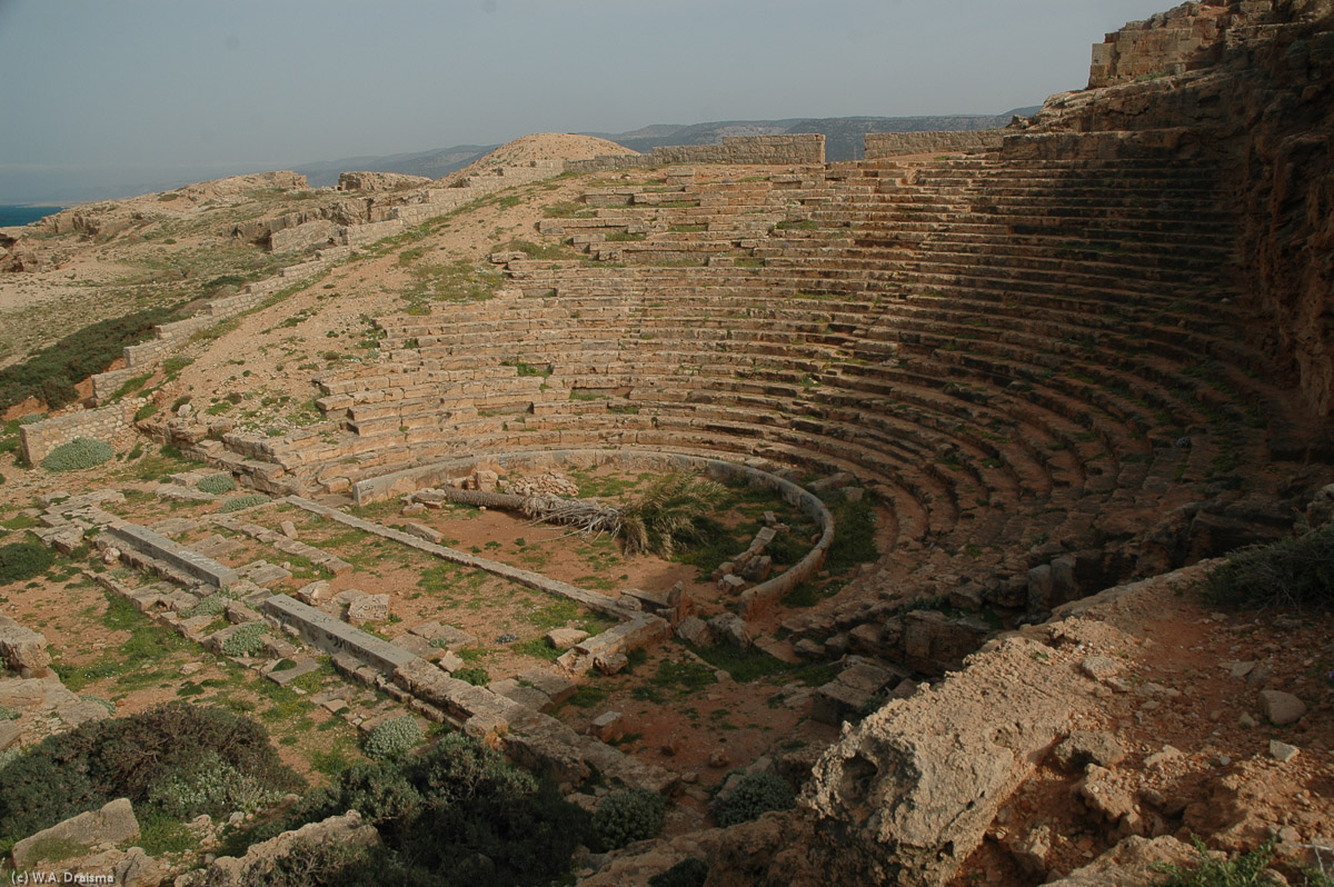 Over the hills to the east of Apollonia is the plunging Greek theatre , which stood outside the walls of the ancient city.