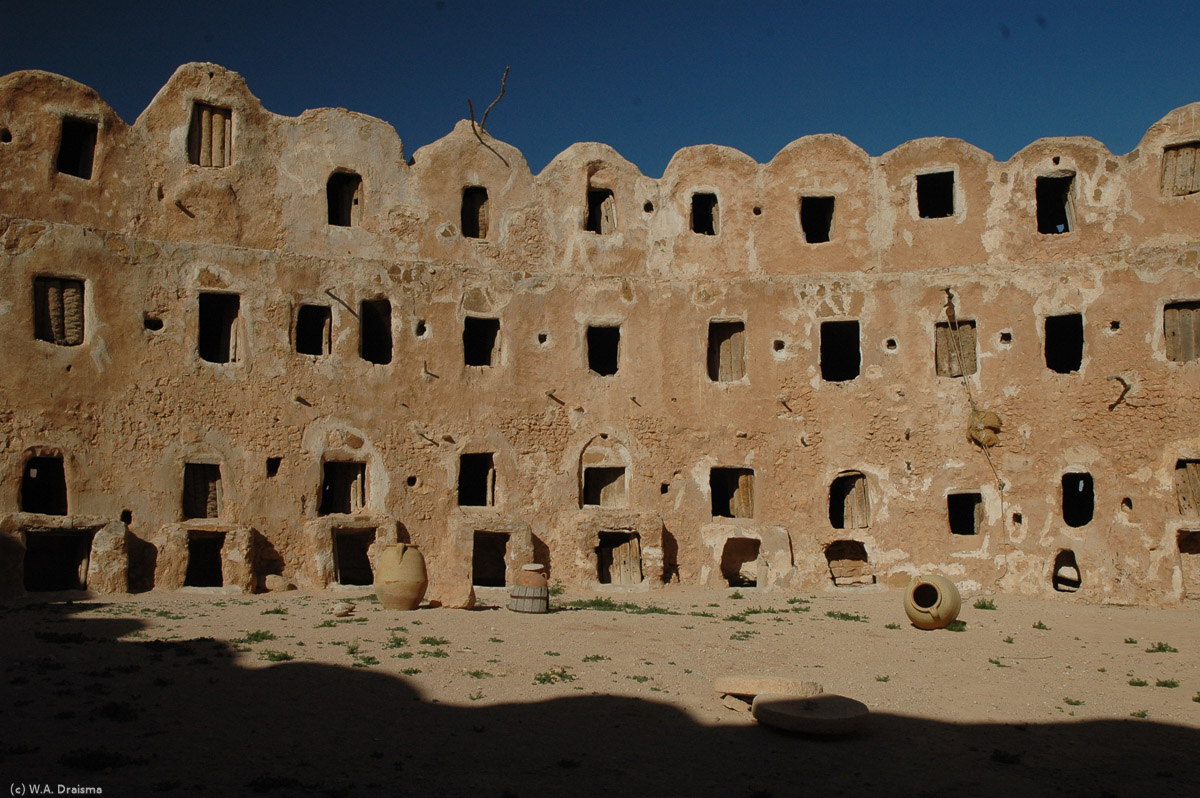 The walls of the main courtyard are completely surrounded by cave-like rooms. There are three storeys above the ground and one below. Each storage area is about 2m deep from the door to the back and some are subdivided into pens for different crop types.