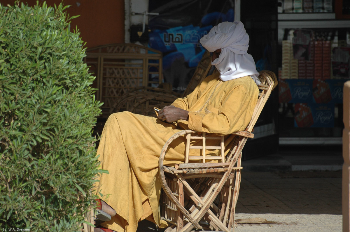 A Tuareg reading in the shade.