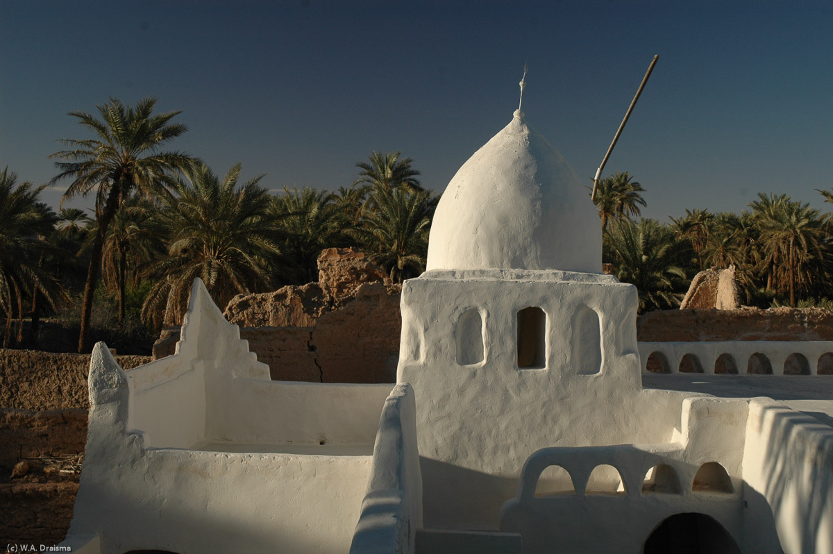 The tower of the old madrassas lit by the setting sun.