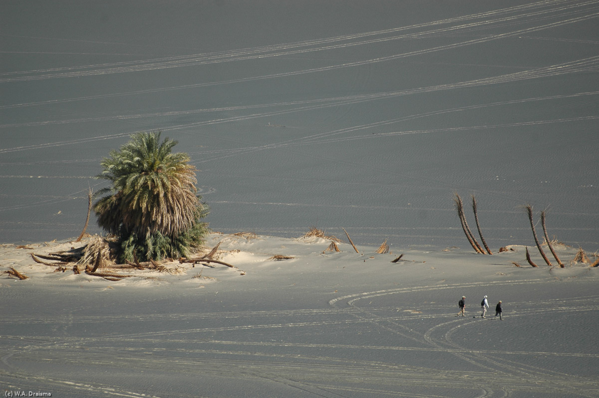 Far below other visitors of Waw an Namus make their own strolls over the crater floor.