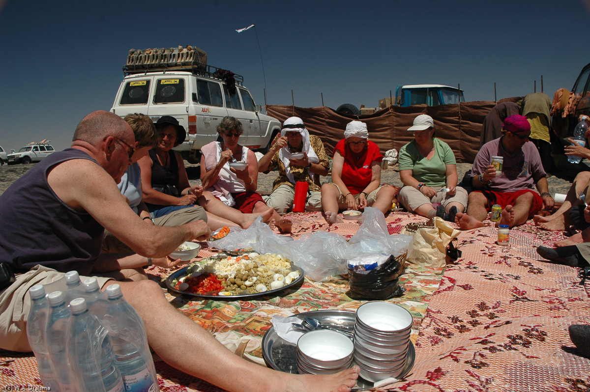 Climbing out of the volcano is hard work. Every step up the slope of the crater results in sliding half a step back down again. Meanwhile the sun's burning high in the sky. Many short stops later we're out and both lunch and drinks are waiting for us.