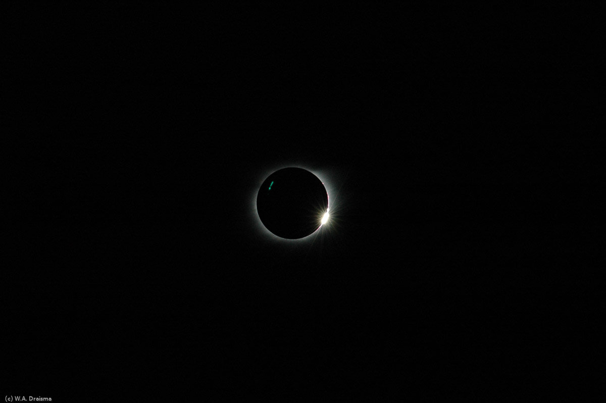 The first ray of the sun's light (or last) that reaches earth through a valley on the moon's surfaces results in the so-called Diamond Ring. As the eclipse ends, more rays reach earth resulting in the so-called Bailey's Beads or String of Pearls.