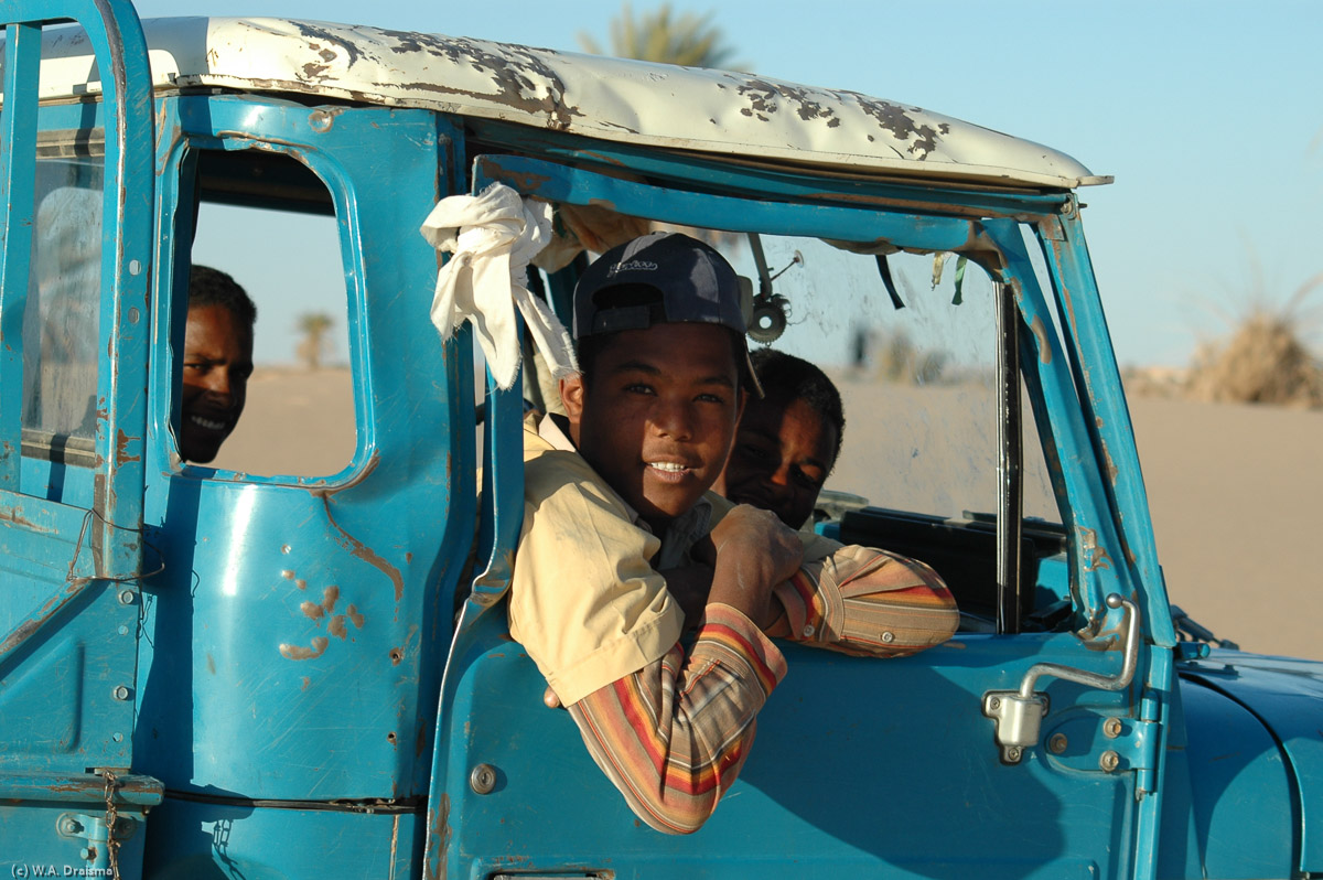 An old jeep with some friendly Libyans passes by.