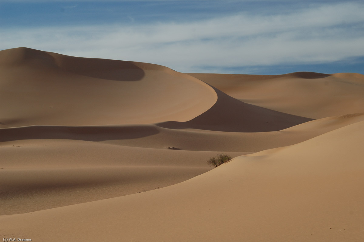 We're camping on the base of an enormous dune. In the distance there's another dune, gradually curving and with a razorsharp edge.