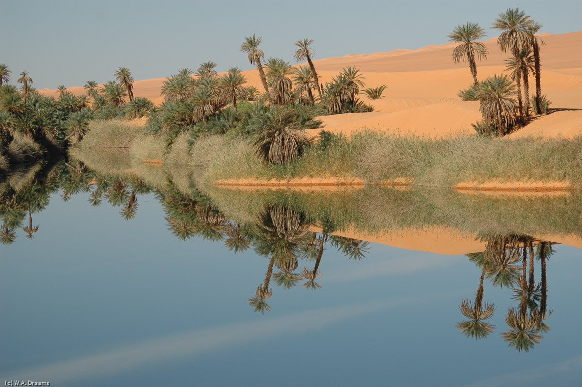 Imagine an ancient caravan travelling through the Sahara. Imagine that they've traveled for days without seeing water. Imagine the moment they reach the steep ridge we've driven down over. Imagine the amazement on seeing Um al-Maa.