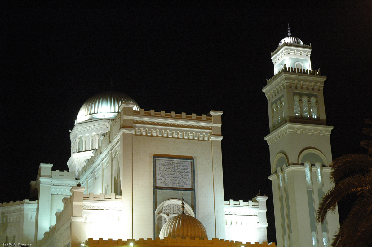 The towering steeple is now the mosque's minaret. Behind the former cathedral the domed National Library.