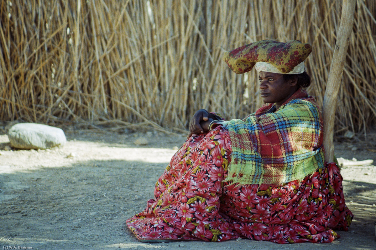 A Herereo woman resting in the shade.