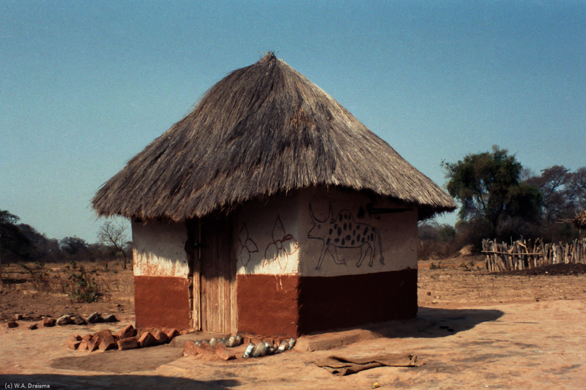 Further on the road to Masvingo, we stop in a tiny settlement where we're given a tour by our driver Henry. There are several kinds of thatched huts like storage huts, sleeping huts, kitchen huts.
