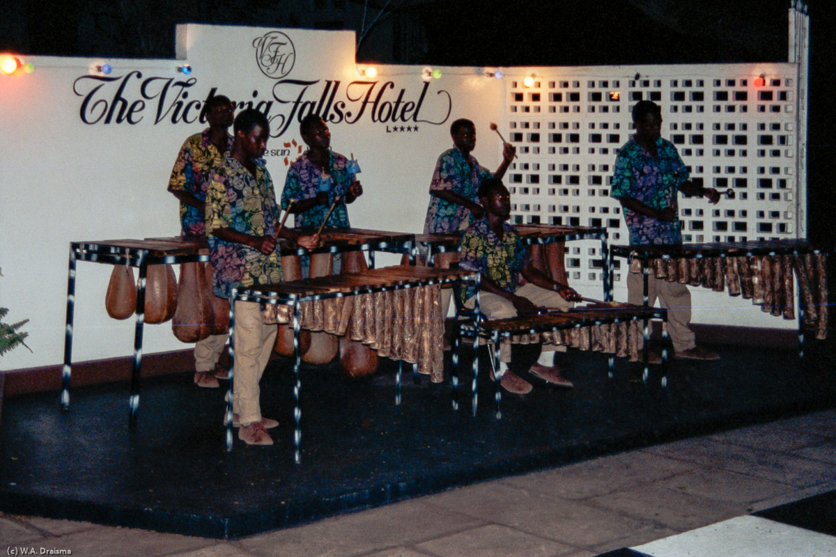 Marimba music accompanies dinner at the Victoria Falls Hotel. The hotel was opened in 1904 to accommodate passengers on the newly built railway and is dramatically situated, with a view of the Second Gorge and the Victoria Falls Bridge from its terrace.
